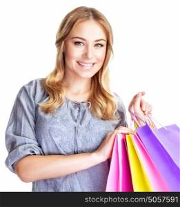 Closeup portrait of happy shopper girl with four colourful paper bags isolated on white background, doing purchase, sale and spending money conception