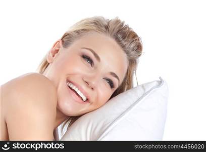 Closeup portrait of happy smiling girl lying down on the pillow isolated on white background, awake from sleep with pleasure, happiness and enjoyment concept
