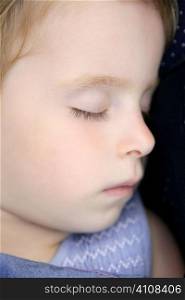 Closeup portrait of little blond child sleeping in peace