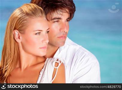 Closeup portrait of lovely couple looking in side on blue sea background, boyfriend and girlfriend enjoying summer vacation