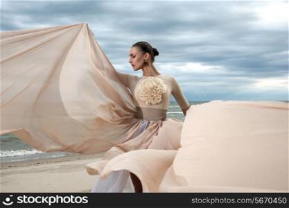 Closeup portrait of model face during posing with long dress at beach