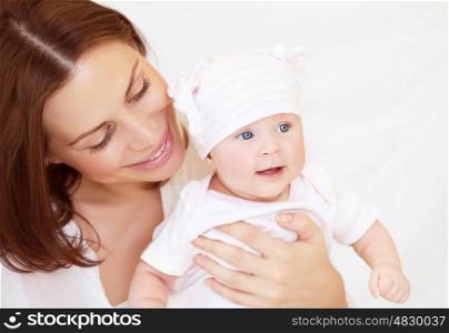 Closeup portrait of mother looking on her cute toddler, happy baby girl with mom at home, happy togetherness concept