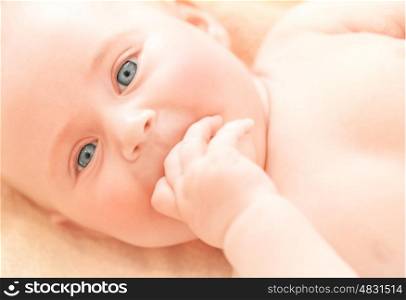 Closeup portrait of newborn child, cute face of adorable baby, happy childhood, kid's health care, toddler at home, love and new life concept