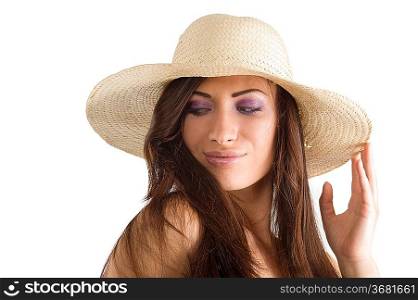 closeup portrait of pretty brunette woman wearing a nice summer hat with long hair