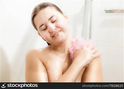 Closeup portrait of serene brunette woman relaxing in shower