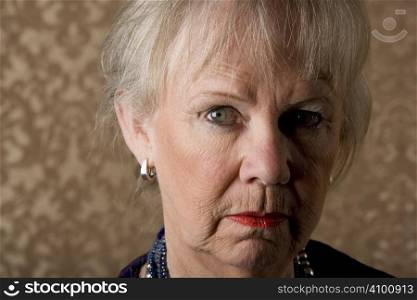 Closeup portrait of skeptical senior woman with bright lipstick