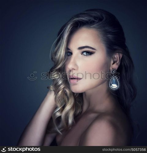 Closeup portrait of stunning woman isolated on dark gray background, sexual model wearing stylish jewelery, beauty salon concept