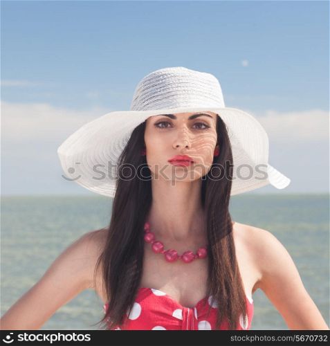 Closeup portrait of stylish woman on the beach