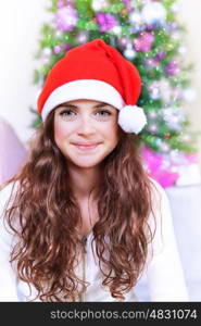Closeup portrait of sweet teen girl on Christmas tree background, New Year childrens party, happy wintertime holidays concept