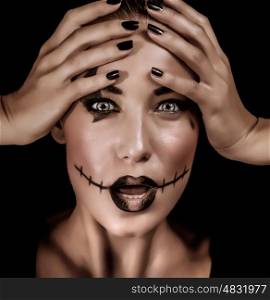Closeup portrait of terrifying witch with spooky painted face and open mouth isolated on black background, Halloween holiday concept