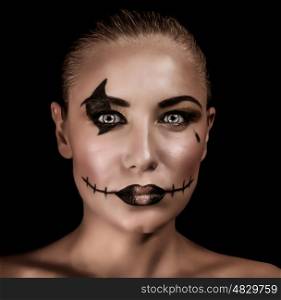 Closeup portrait of terrifying witch with spooky painted face and torn mouth isolated on black background, Halloween holiday concept