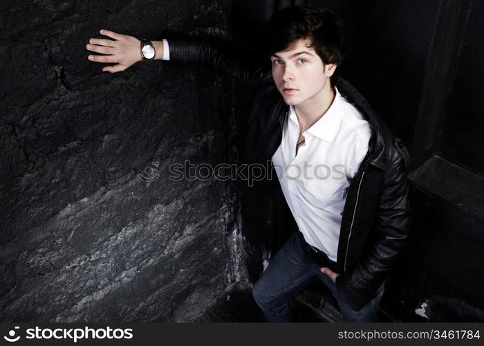 Closeup portrait of the beautiful young sexual man, on a black background