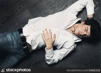 Closeup portrait of the beautiful young sexual man, on a black background