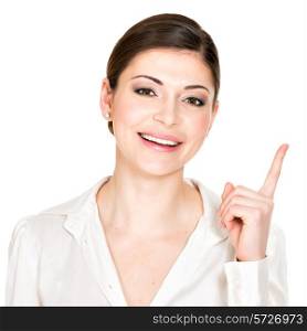 Closeup portrait of the young happy woman with points up sign in white shirt - isolated on white background.