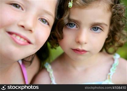 closeup portrait of two little happy beautiful girl sisters