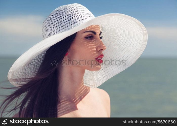 Closeup portrait of woman in big white hat