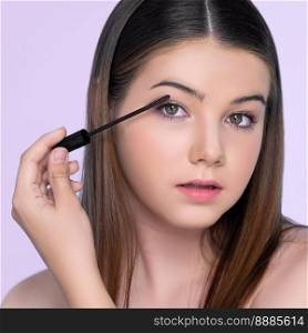 Closeup portrait of young charming applying makeup eyeshadow on her face with brush, mascara with flaw≤ss smooth skin for beauty concept.. Closeup portrait of young charming applying makeup eyeshadow with brush.