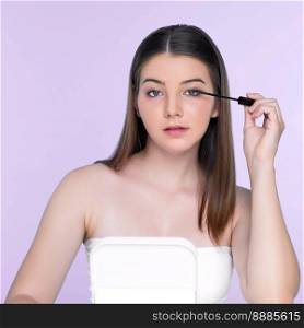 Closeup portrait of young charming applying makeup eyeshadow on her face with brush, mascara with flawless smooth skin for beauty concept.. Closeup portrait of young charming applying makeup eyeshadow with brush.
