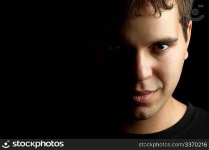 closeup portrait of young man isolated on black background