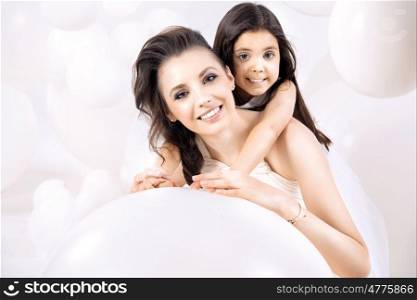 Closeup portrait of young mom with a cute little daughter