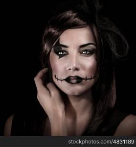 Closeup portrait of young woman with scary makeup isolated on black background, carnival costume of witch, Halloween party concept