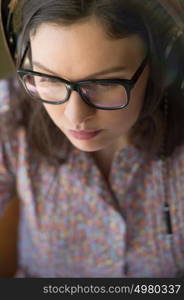 Closeup portrait of young woman working at home in front of monitor