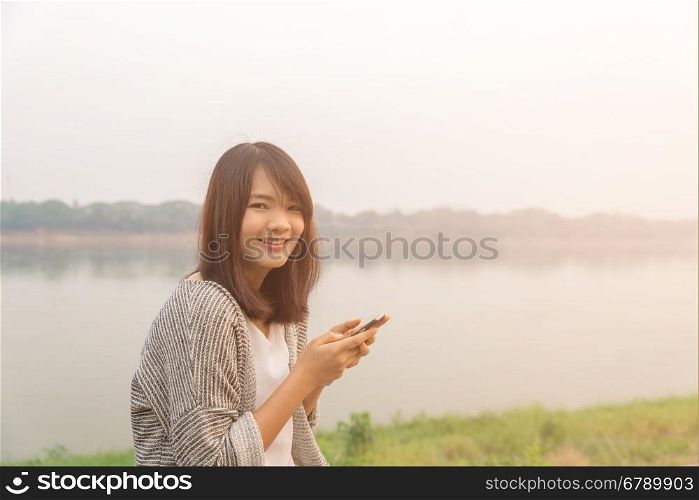 Closeup portrait upset sad skeptical unhappy serious woman talking texting on phone displeased with conversation isolated park outdoors background. Negative human emotion face expression feeling