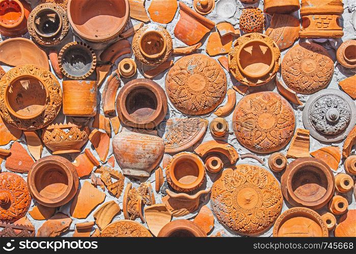 Closeup Pottery thai and brown texture background on wall for interior or exterior decoration.