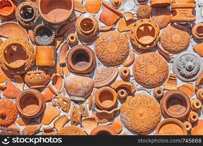 Closeup Pottery thai and brown texture background on wall for interior or exterior decoration.