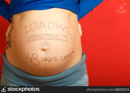 Closeup pregnant woman belly with loading concept painted on her tummy, creativity in the stage of uterine development, awaited new baby