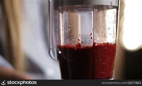 Closeup process of blending food ingredients in blender shaker jug while making fresh vegetable smoothie. Healthy eating lifestyle, vegetarian food and dieting.