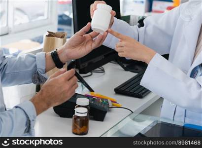 Closeup professional pharmacist advise or explain property of qualified medical product to customer in pharmacy, druggist answer to client healthcare inquiry, medical service and consultation concept.. Pharmacist advise or explain property of qualified medical product to customers.