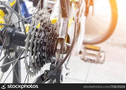 Closeup road bike gear and wheel under morning sunlight. Closeup road bike gear and wheel
