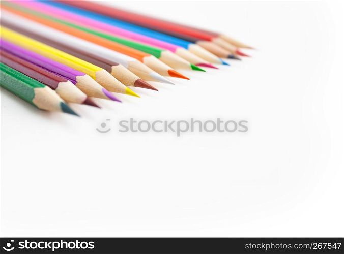 Closeup, Selective focus on the tips of the colorful crayon pencils on white background with copy space.