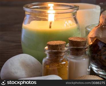 closeup set ingredients and spice for aromatherapy and body care. burning candle flame. SPA still life. the attributes of aromatherapy