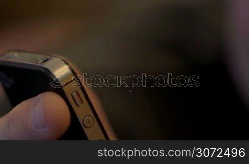 Closeup shot of a smartphone in man&acute;s hand, then man&acute;s eyes are in shot.