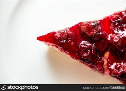 Closeup shot of cherry cheesecake on white dish