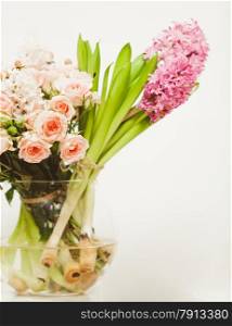Closeup shot of different flowers standing in glass vase