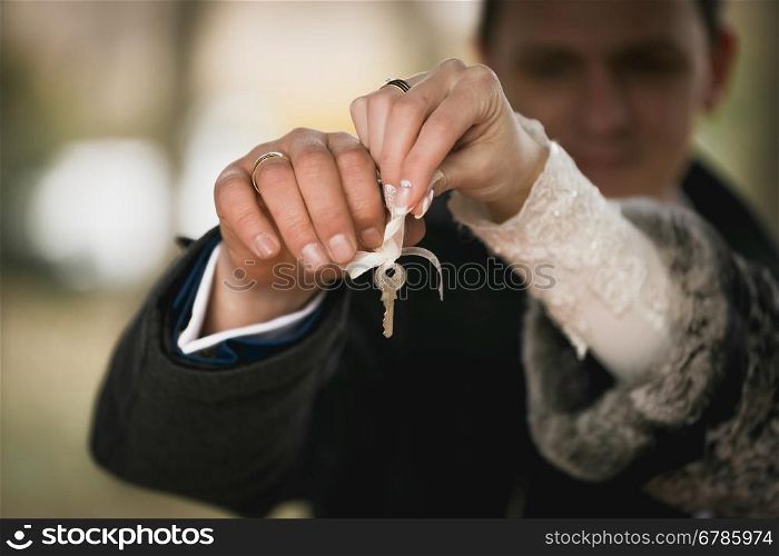 Closeup shot of happy couple holding decorative key