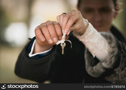 Closeup shot of happy couple holding decorative key