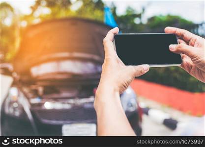 Closeup shot of man using smartphone with isolated screen after car accident
