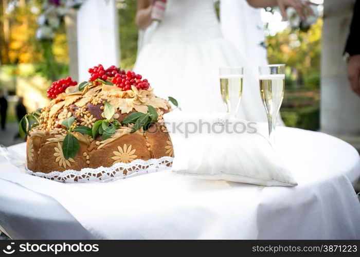 Closeup shot of traditional orthodox wedding bread lying on ceremonial table