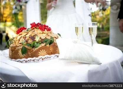 Closeup shot of traditional orthodox wedding bread lying on ceremonial table