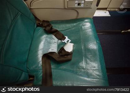 Closeup shot of unfastened belt on seat at airplane