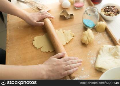 Closeup shot of young woman making sweet dough for cookies