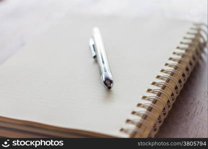 Closeup spiral notebook and pen, stock photo