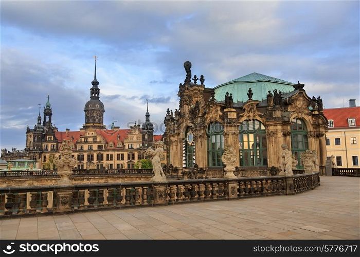 Closeup stone figure and Residenzschloss (city hall) on the back at Zwinger palace in Dresden, Germany&#xA;