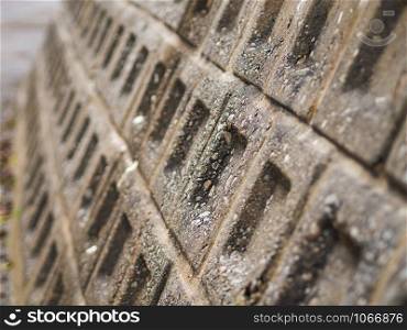 Closeup stone wall textured in shallow depth of field. Abstract background with selective focus.