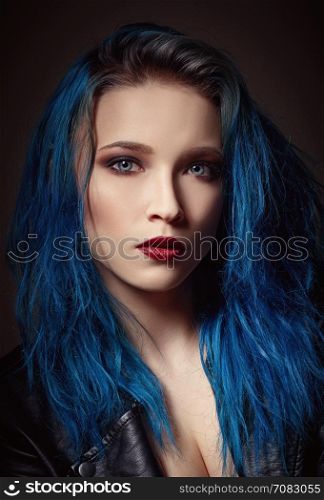 Closeup studio portrait of a beautiful young woman with blue hair
