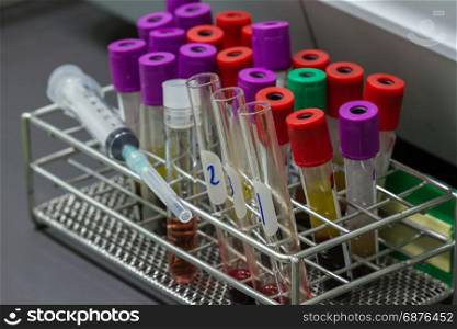 Closeup test tubes with blood for medical and biological analyzes, medicine equipment and health concept